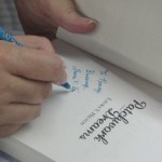 Author Laura Hilton sign another book
