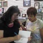 Laura Hilton, Author and Horseshoe Bend resident signs another copy of her new book