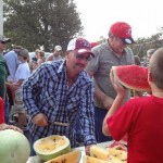 Chad Wooldridge cuts up watermelon for the Watermelon Feed